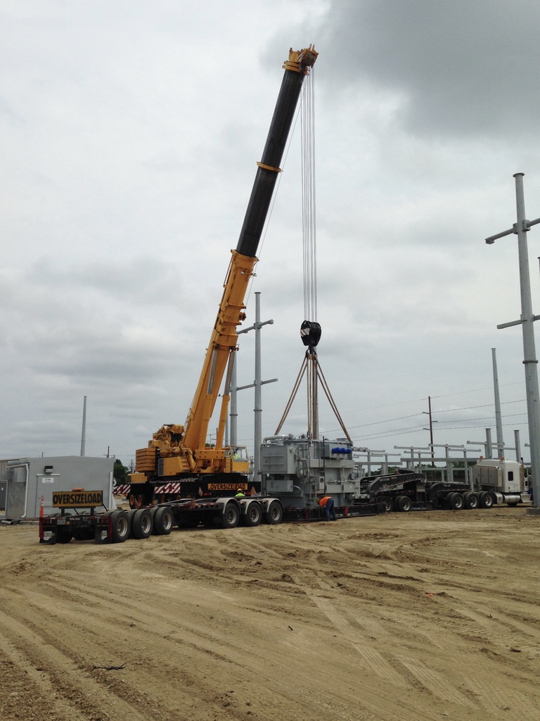 Crane setting equipment at an electrical substation